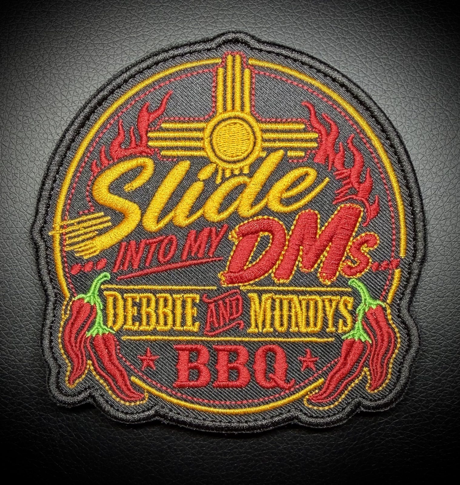 Slide Into My DMs round business patch for Debbie and Mundys BBQ with Zia sun, flames, and red chiles