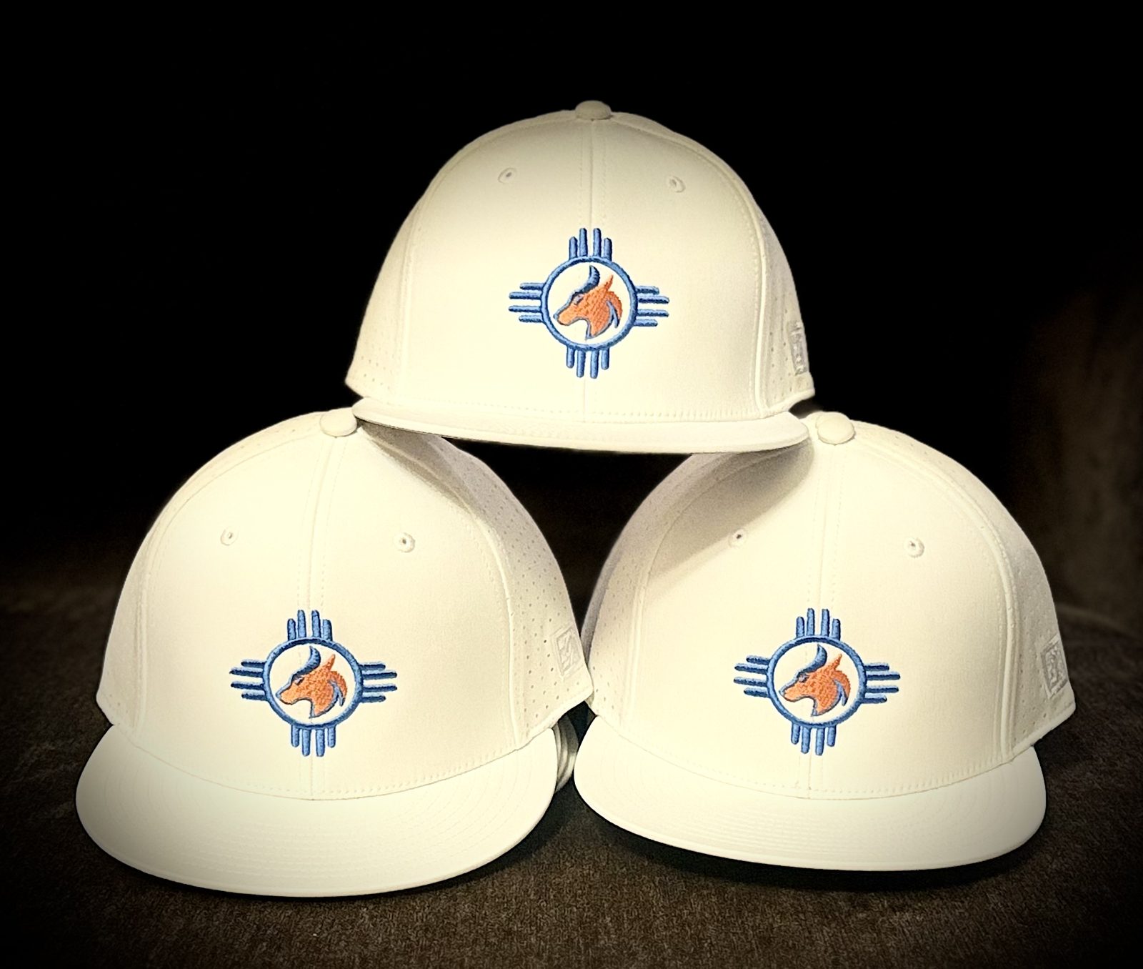 White fitted caps with embroidered horse and Zia sun logo